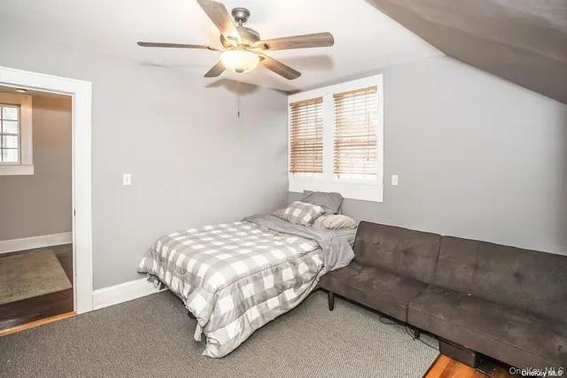 a bedroom with bed and a window