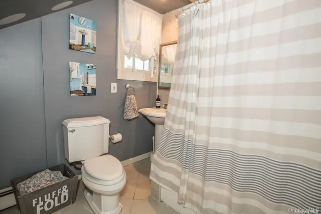 a white toilet sitting next to a shower curtain