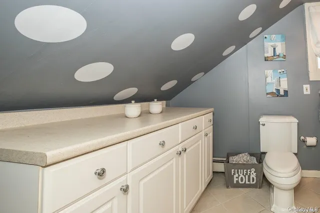 a bathroom with a toilet a sink and a mirror