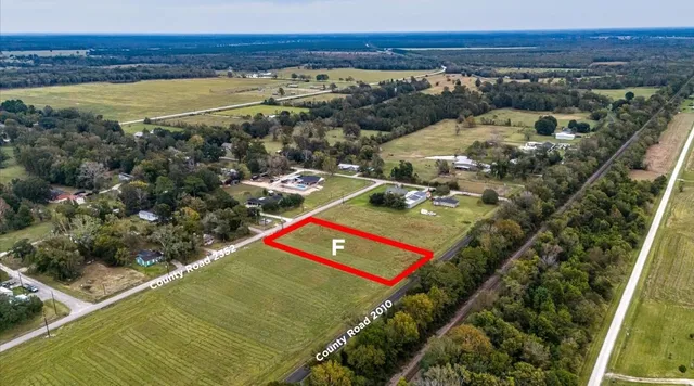 an aerial view of a pool a yard and mountain view