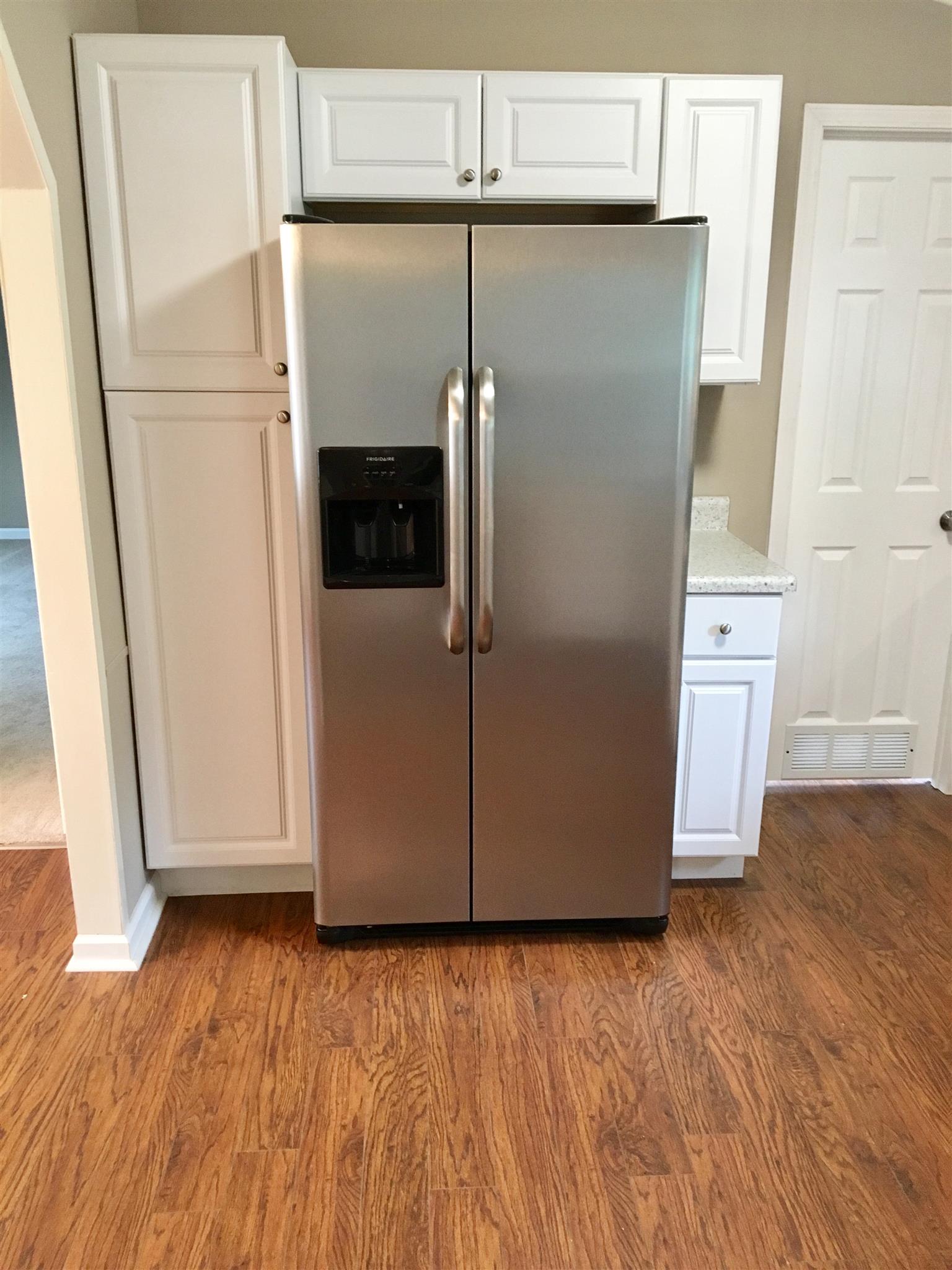 4302 Woodrow Wilson Road Springfield, TN 37172 - Photo 11 of 28 a view of a refrigerator in kitchen and an empty room