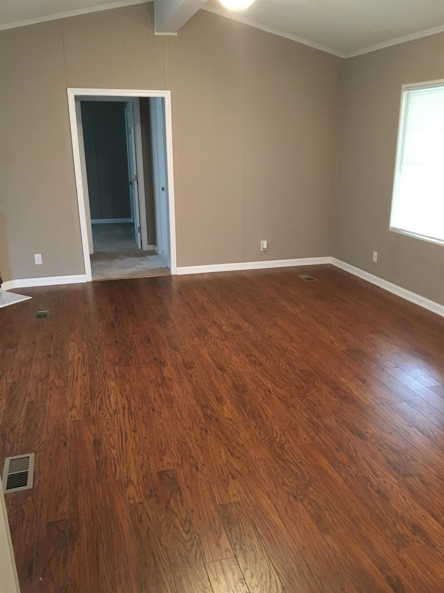 4302 Woodrow Wilson Road Springfield, TN 37172 - Photo 5 of 28 an empty room with wooden floor and windows