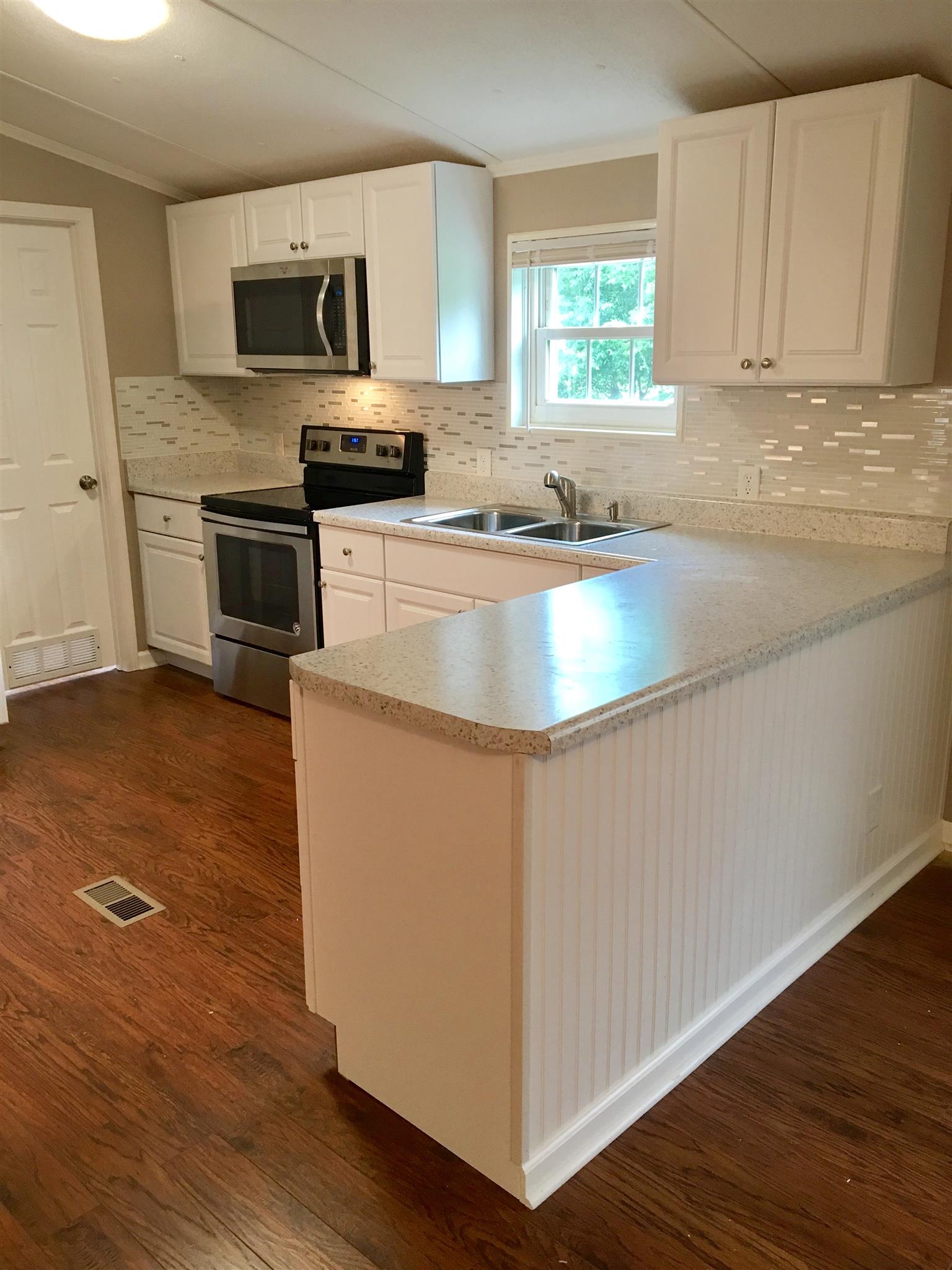 4302 Woodrow Wilson Road Springfield, TN 37172 - Photo 8 of 28 a kitchen with granite countertop a sink cabinets and stainless steel appliances