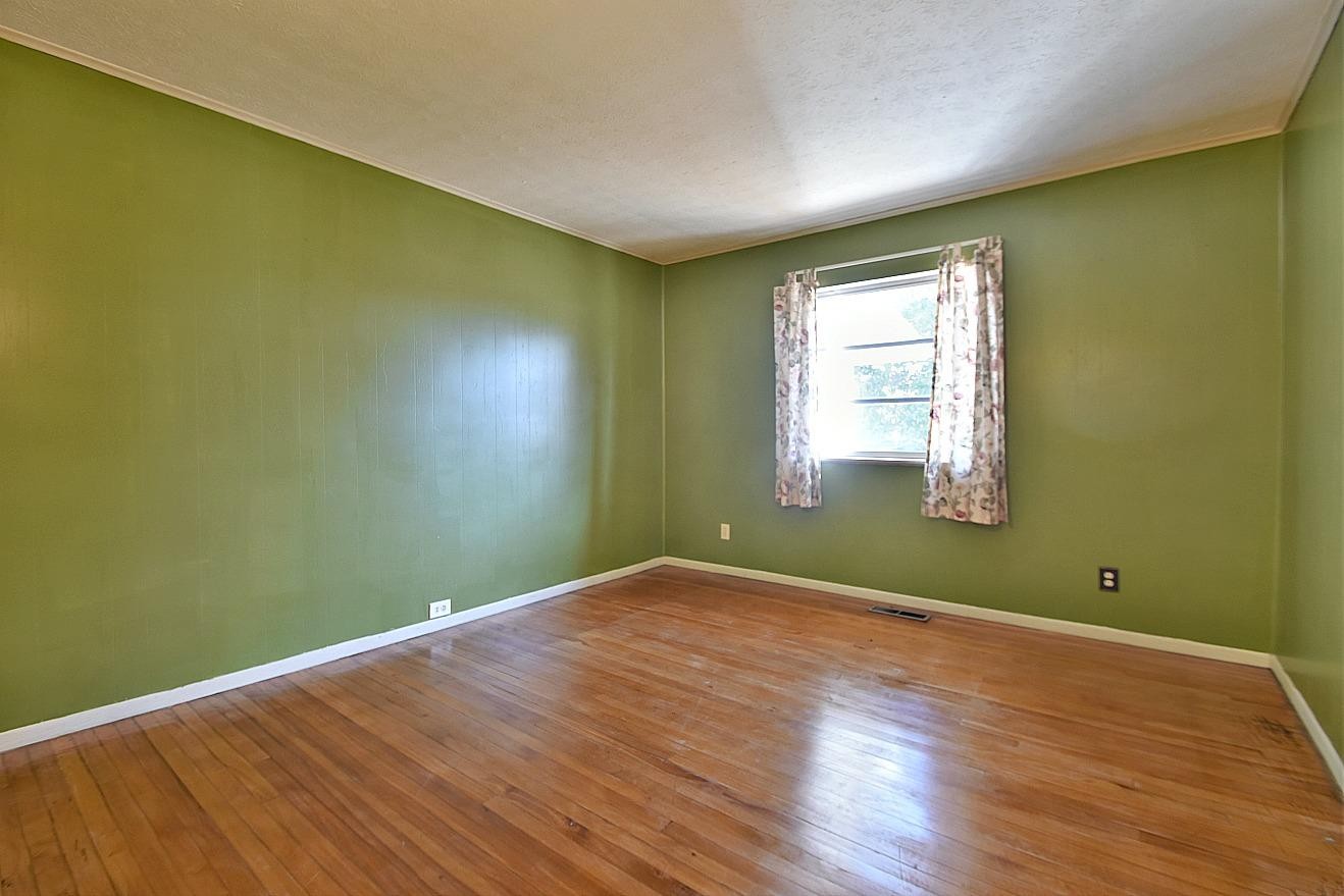 100 Orange Lane Oak Ridge, TN 37830 - Photo 11 of 19 a view of empty room with wooden floor and fan