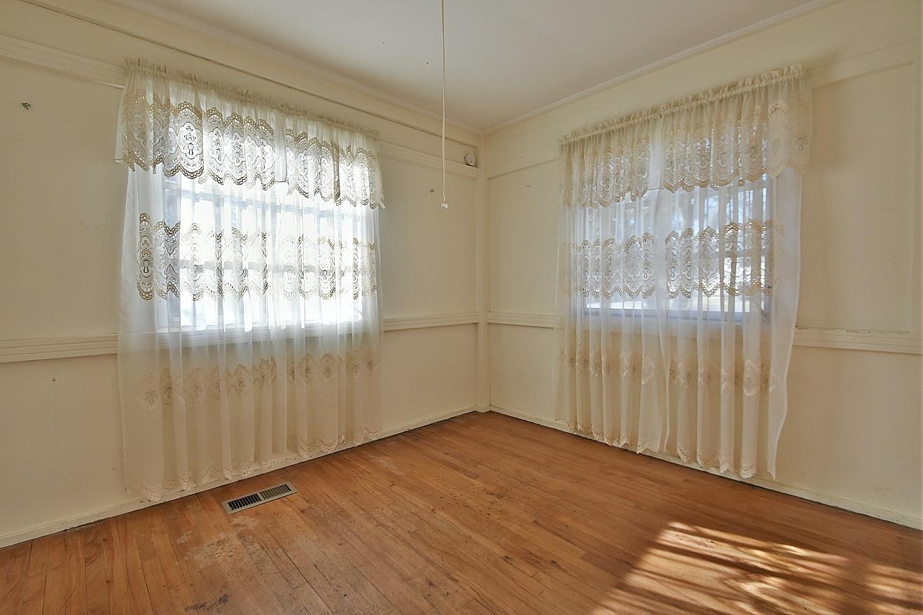 100 Orange Lane Oak Ridge, TN 37830 - Photo 14 of 19 a view of an empty room with wooden floor and a window