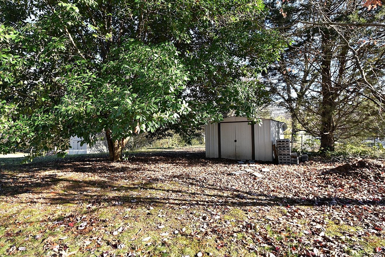 100 Orange Lane Oak Ridge, TN 37830 - Photo 18 of 19 a white house covered with tall trees
