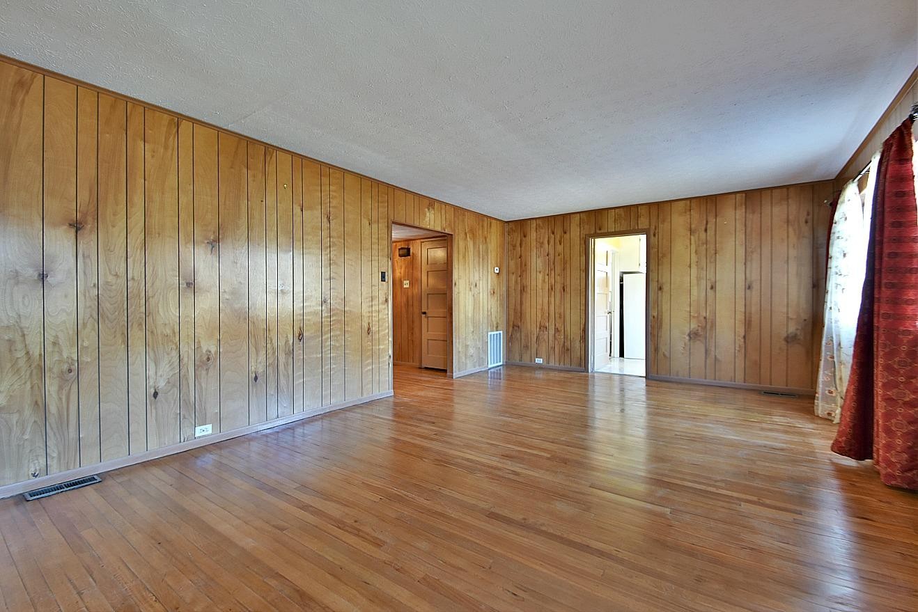 100 Orange Lane Oak Ridge, TN 37830 - Photo 5 of 19 a view of an empty room with wooden floor and a window
