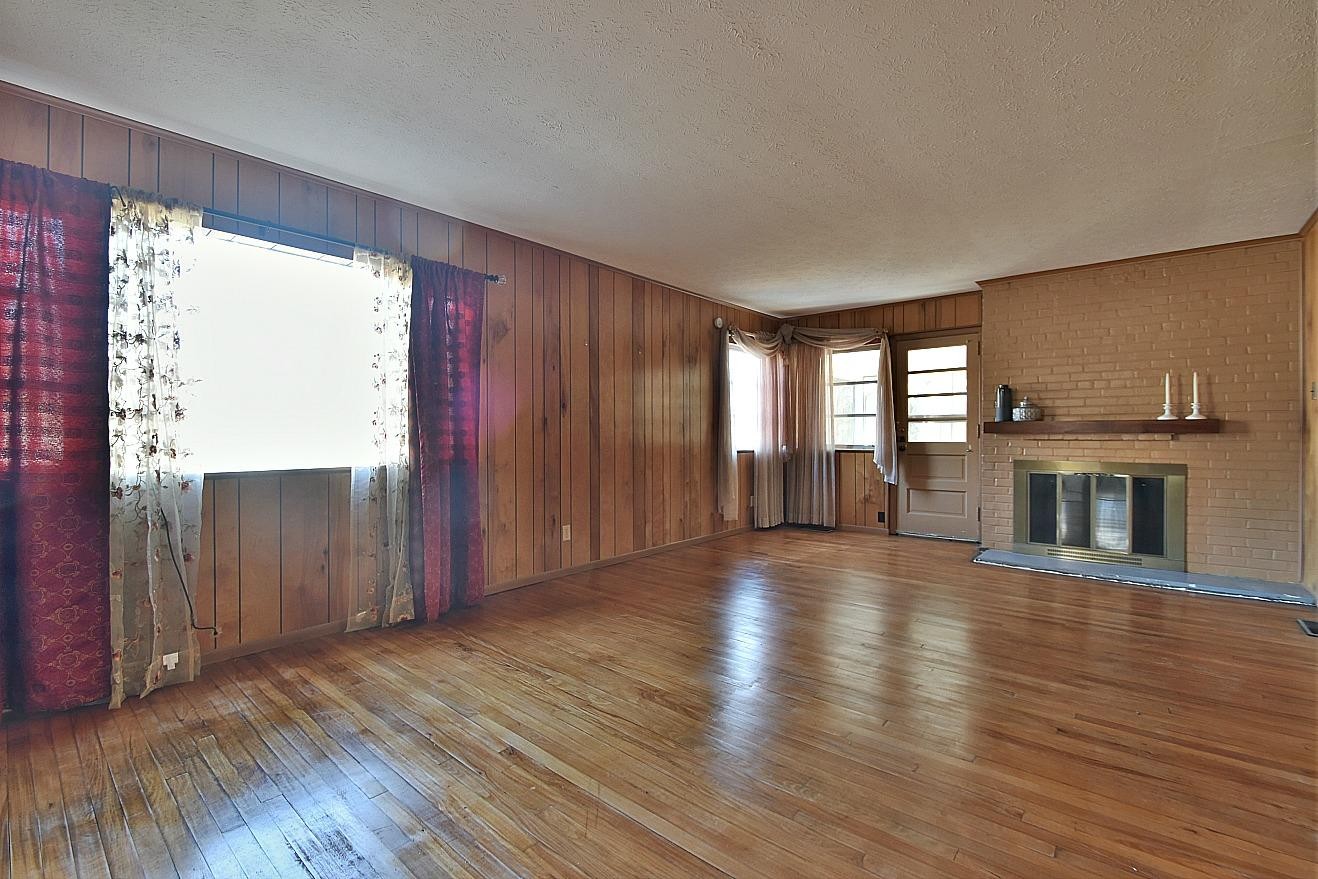 100 Orange Lane Oak Ridge, TN 37830 - Photo 6 of 19 a view of a room with wooden floor and fireplace