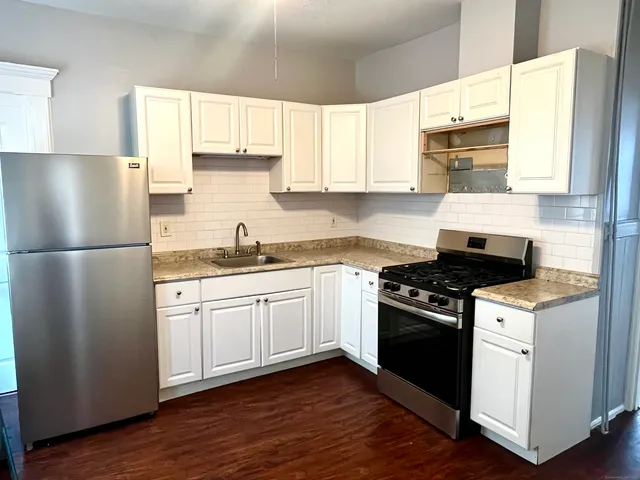 a kitchen with a stove a sink and a refrigerator
