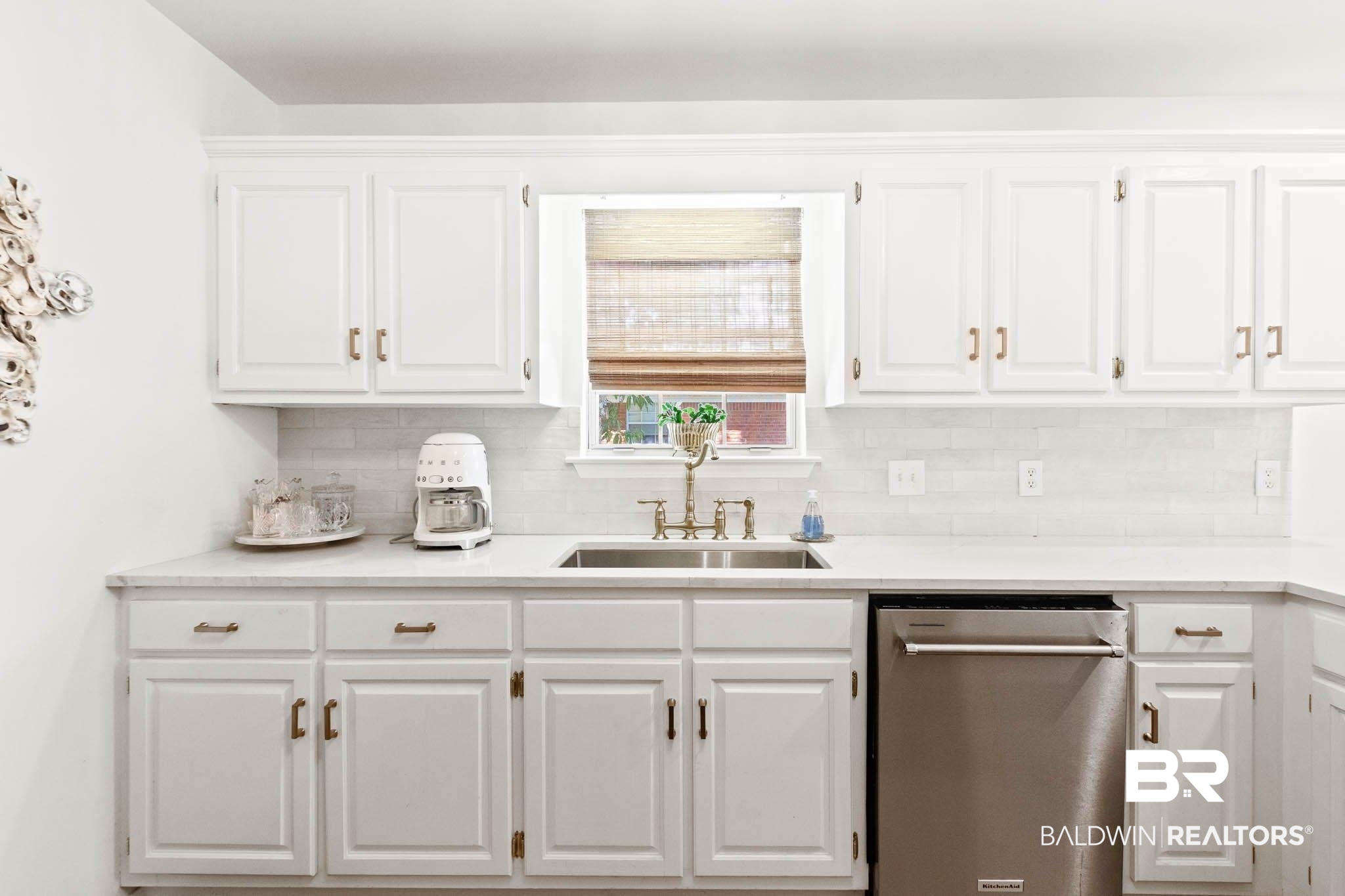 20685 Lowry Drive Fairhope, AL 36532 - Photo 19 of 48 Kitchen with white cabinets, stainless steel dishwasher, backsplash, and light stone countertops