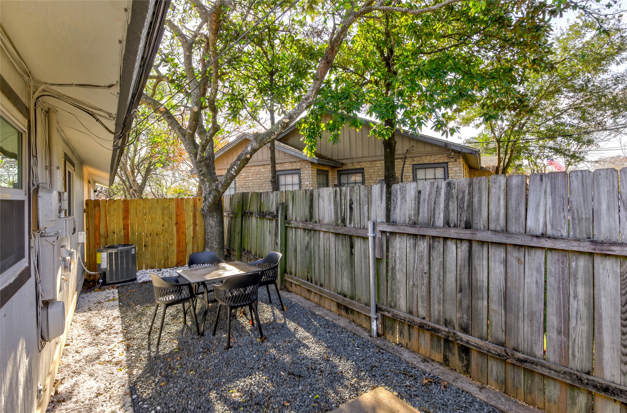 10509 Macmora Road, Unit A Austin, TX 78758 - Photo 13 of 17 A secluded patio with privacy fencing offers a charming outdoor dining space.