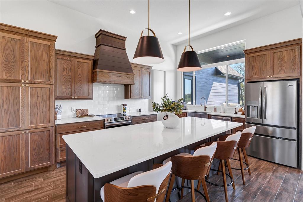 2105 Rattler Way Tolar, TX 76476 - Photo 11 of 30 a kitchen with stainless steel appliances granite countertop a refrigerator a sink dishwasher a stove and a refrigerator with wooden floor