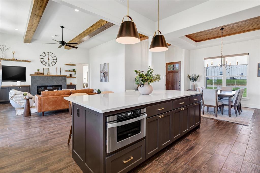 2105 Rattler Way Tolar, TX 76476 - Photo 14 of 30 a kitchen with stainless steel appliances a stove and a wooden floors