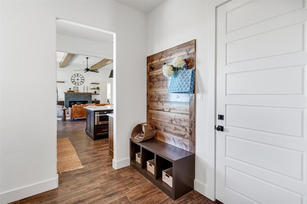 2105 Rattler Way Tolar, TX 76476 - Photo 15 of 30 a view of a hallway to a livingroom and a dining room with wooden floor