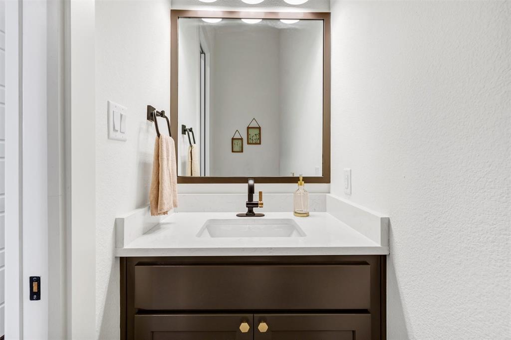 2105 Rattler Way Tolar, TX 76476 - Photo 16 of 30 a bathroom with a sink and a mirror