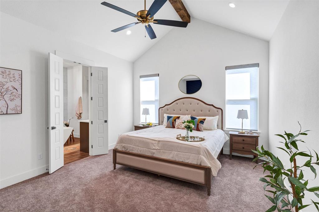 2105 Rattler Way Tolar, TX 76476 - Photo 18 of 30 a bedroom with a bed and a chandelier