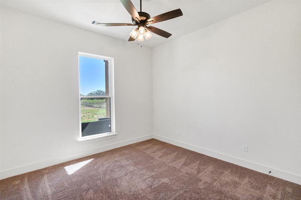 2105 Rattler Way Tolar, TX 76476 - Photo 24 of 30 an empty room with a window and a fan