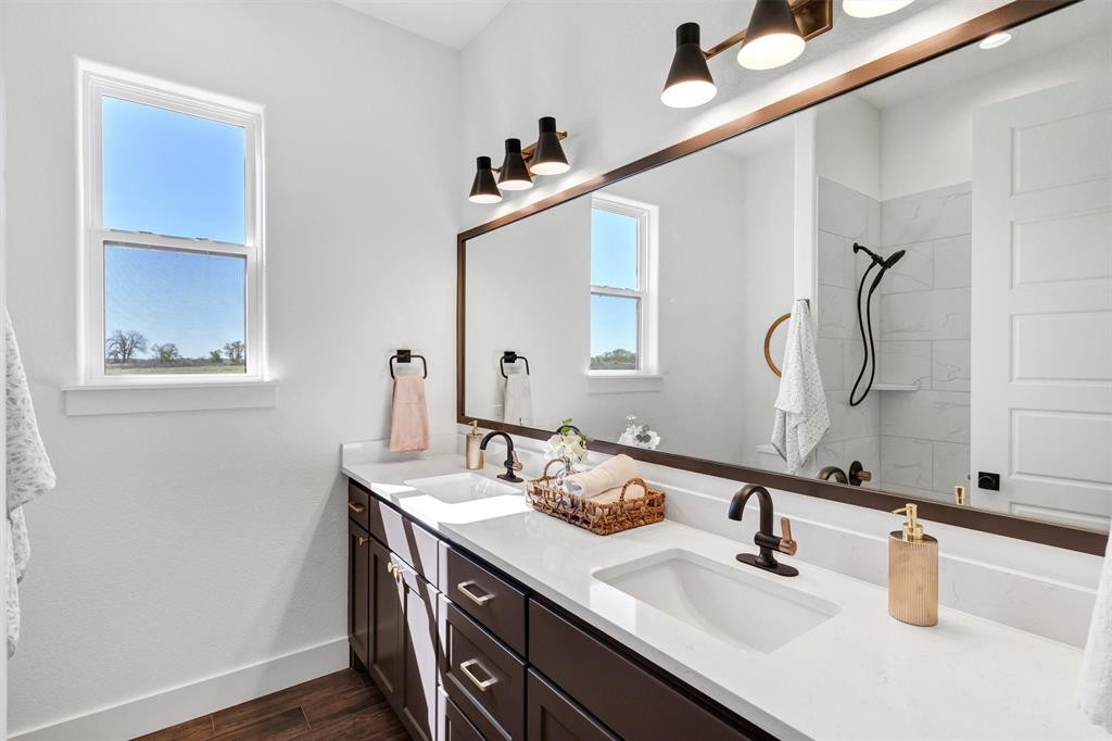 2105 Rattler Way Tolar, TX 76476 - Photo 25 of 30 a bathroom with a sink and a mirror