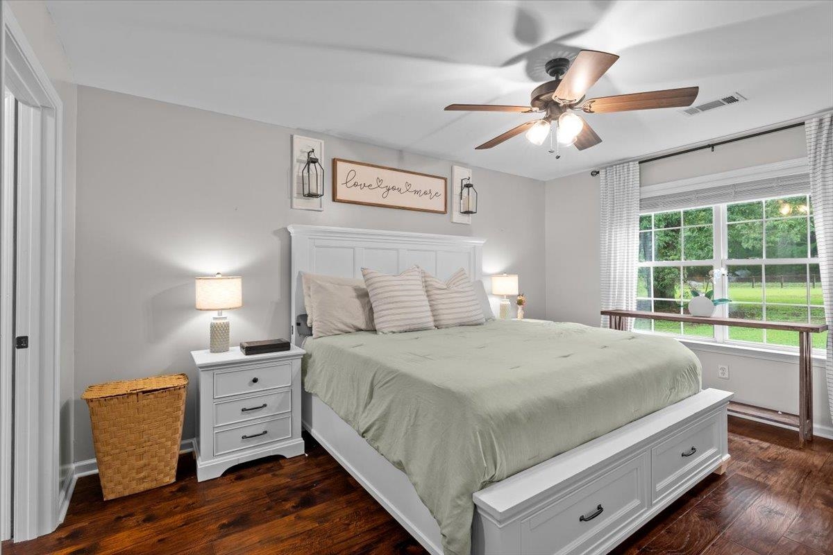 150 Liberty Road Moscow, TN 38057 - Photo 9 of 36 Spacious bedroom featuring wood-finish flooring, a ceiling fan with integrated lighting, and multiple windows