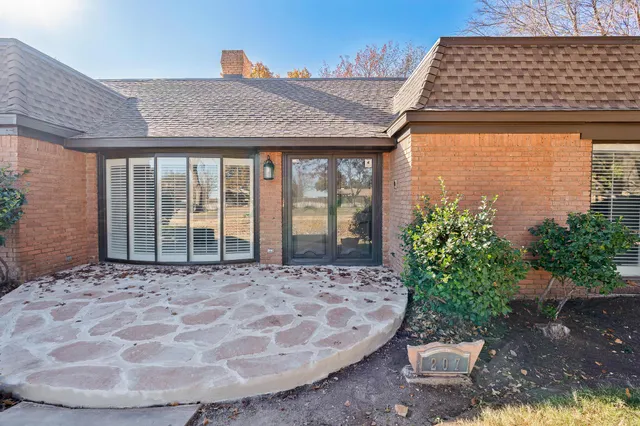 a view of a brick house with potted plants