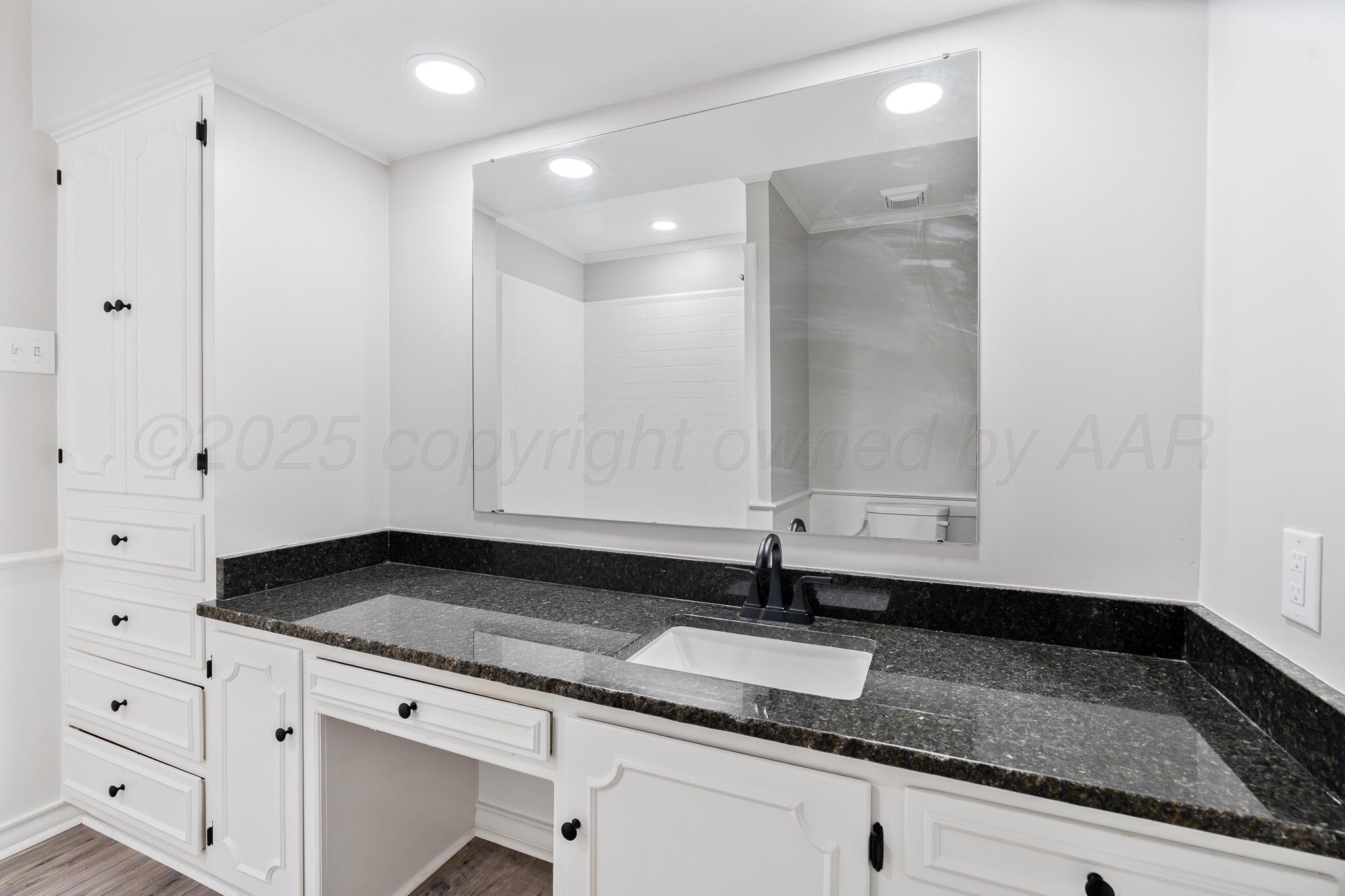 207 Yucca Terrace Plainview, TX 79072 - Photo 31 of 50 a bathroom with a granite countertop sink and a granite