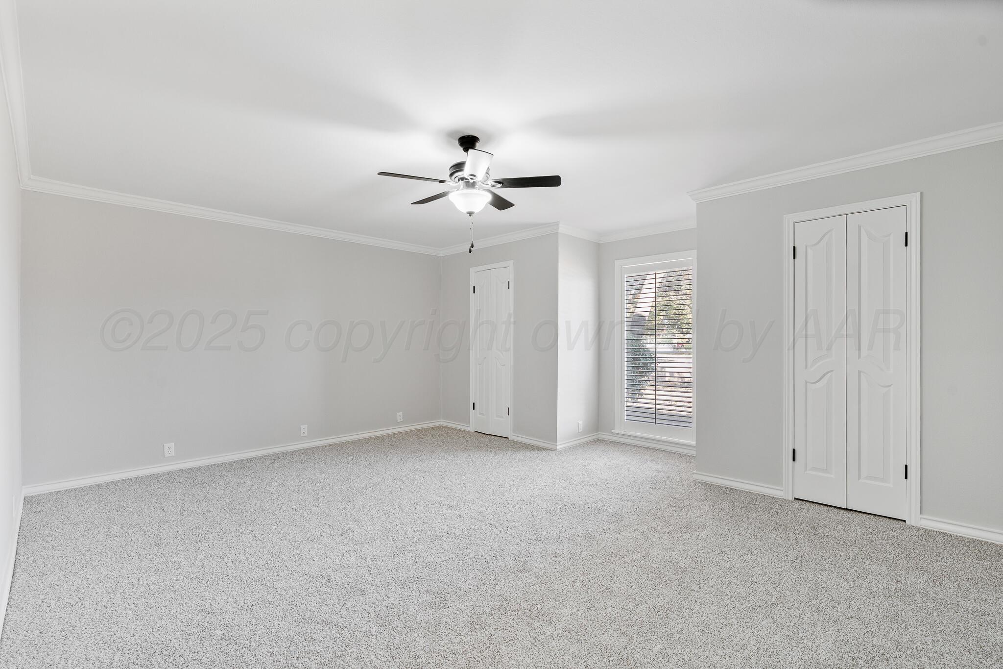 207 Yucca Terrace Plainview, TX 79072 - Photo 33 of 50 a view of an empty room with a ceiling fan