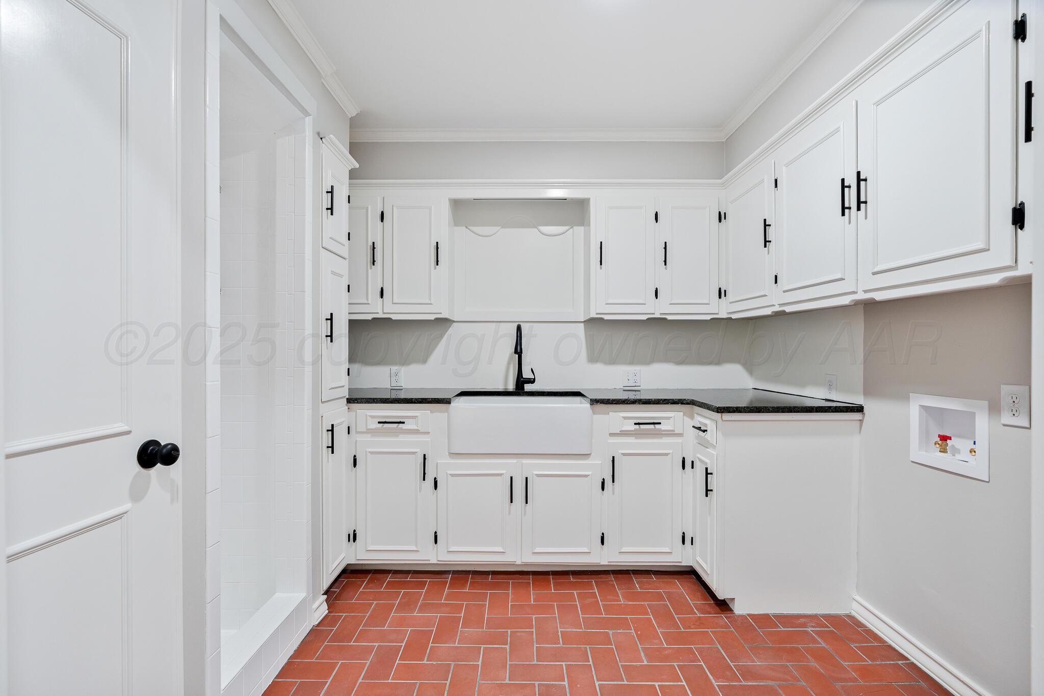 207 Yucca Terrace Plainview, TX 79072 - Photo 35 of 50 a kitchen with white cabinets and sink