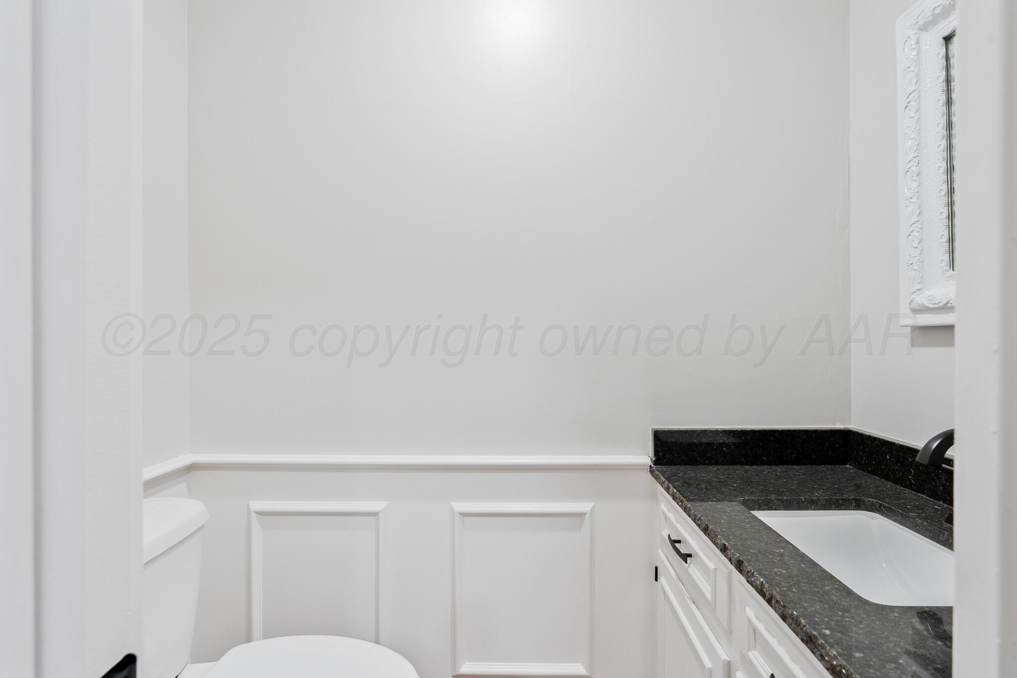 207 Yucca Terrace Plainview, TX 79072 - Photo 36 of 50 a bathroom with a granite countertop sink and a toilet