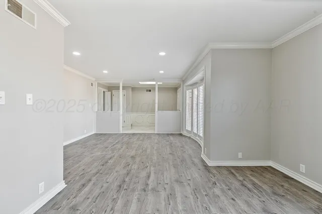 a view of a room with wooden floor and window