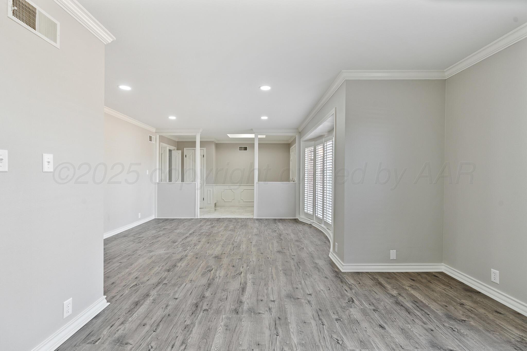 207 Yucca Terrace Plainview, TX 79072 - Photo 5 of 50 a view of a room with wooden floor and window