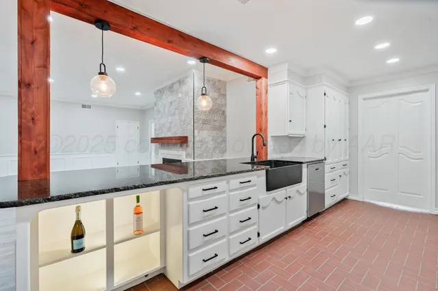 a kitchen with granite countertop white cabinets and white appliances
