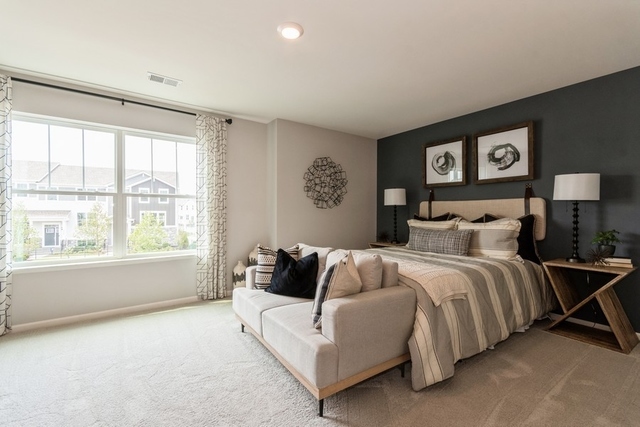 1343 Draper Road McHenry, IL 60050 - Photo 3 of 10 a spacious bedroom with a bed and a large window