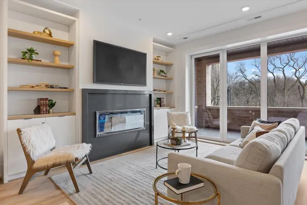 a living room with furniture and kitchen view