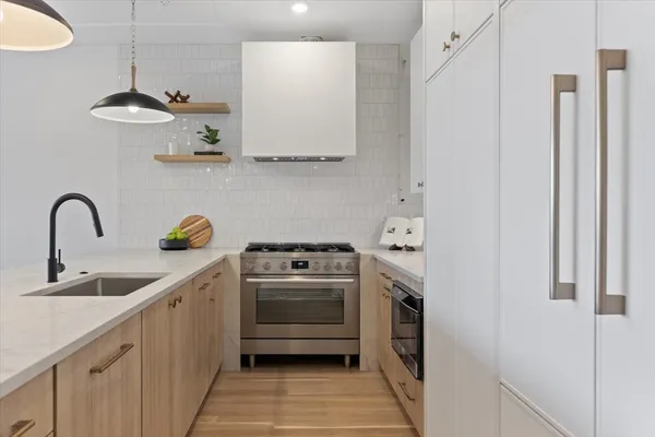 a kitchen with counter top space a sink and appliances