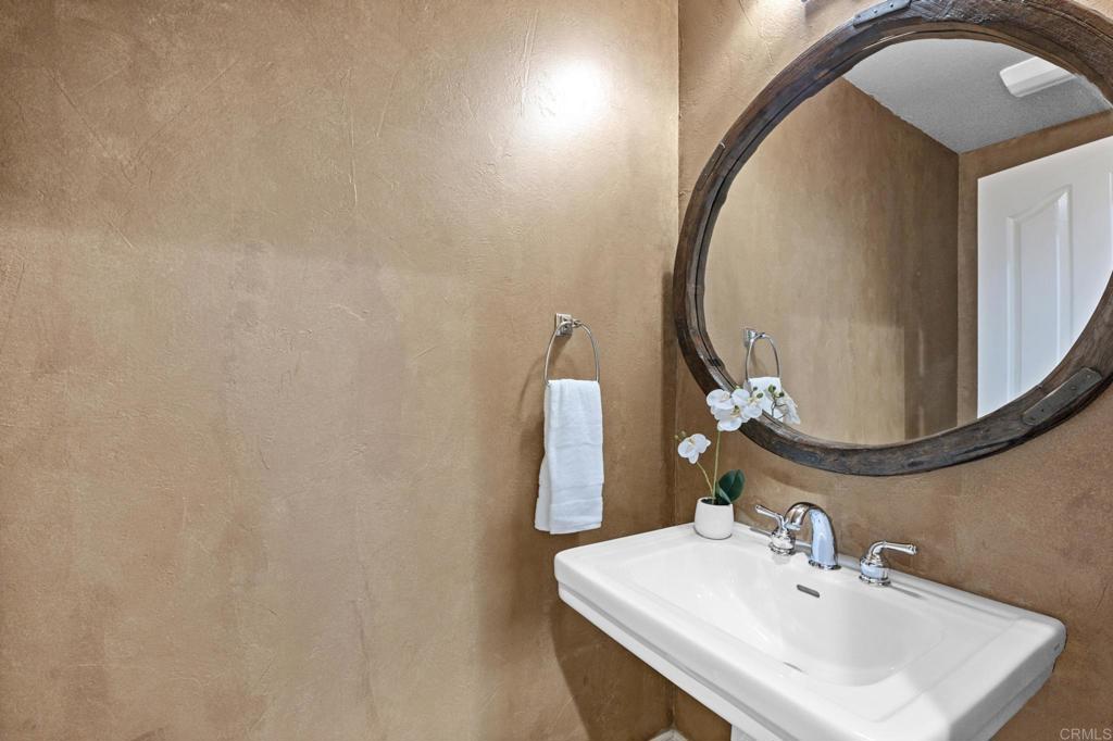 8021 Paseo Arrayan Carlsbad, CA 92009 - Photo 18 of 68 a bathroom with a sink and a mirror