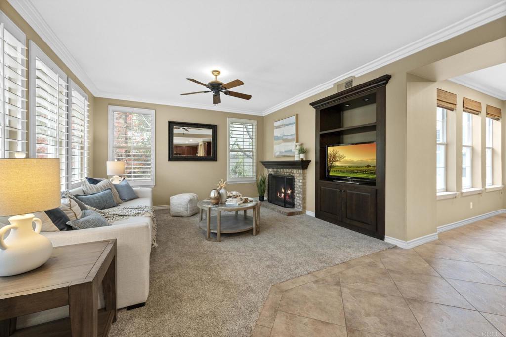 8021 Paseo Arrayan Carlsbad, CA 92009 - Photo 20 of 68 a living room with furniture two large window and flat screen tv