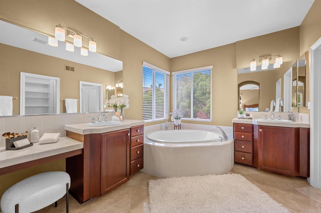 8021 Paseo Arrayan Carlsbad, CA 92009 - Photo 38 of 68 a spacious bathroom with a sink double vanity and a mirror