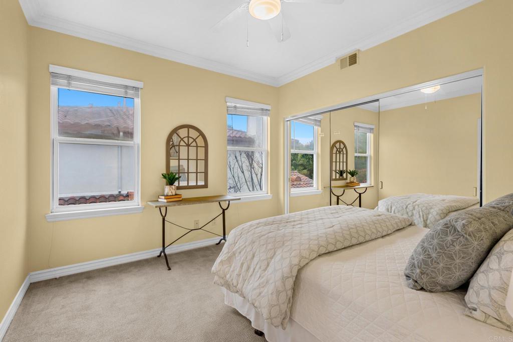 8021 Paseo Arrayan Carlsbad, CA 92009 - Photo 43 of 68 a spacious bedroom with a bed and a dresser