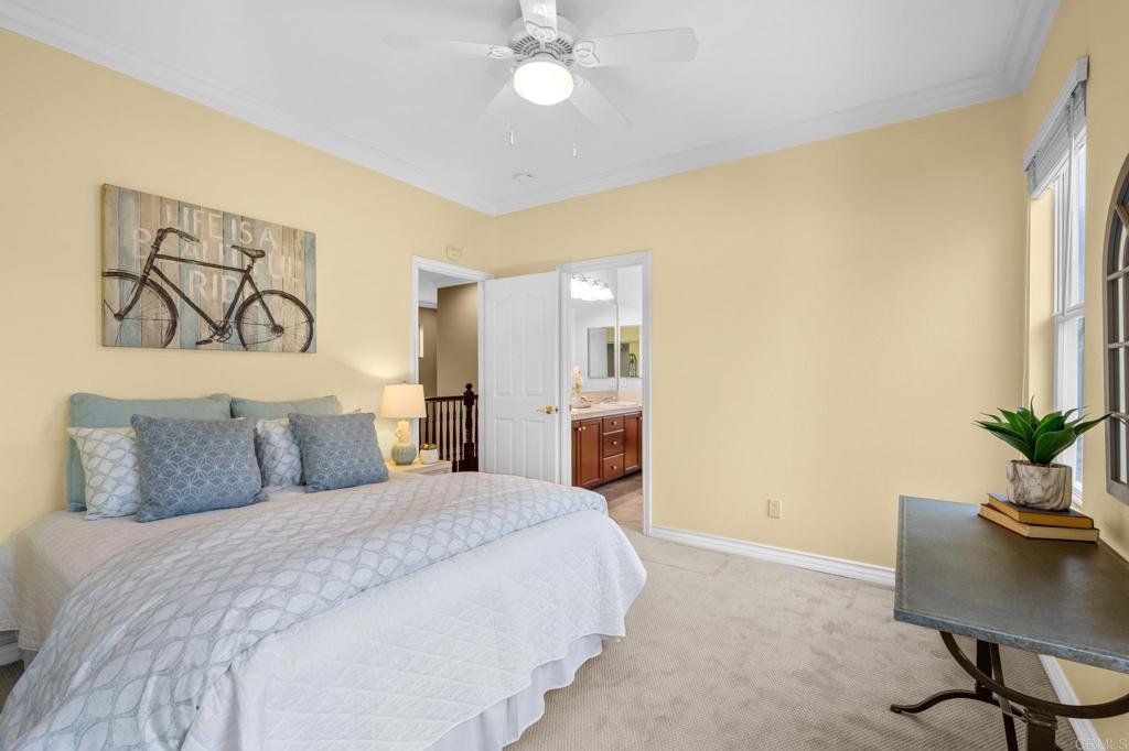 8021 Paseo Arrayan Carlsbad, CA 92009 - Photo 44 of 68 a bedroom with a large bed and a chandelier