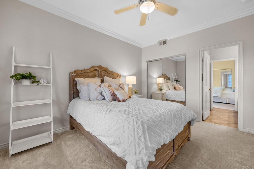 8021 Paseo Arrayan Carlsbad, CA 92009 - Photo 48 of 68 a bedroom with a bed and ceiling fan