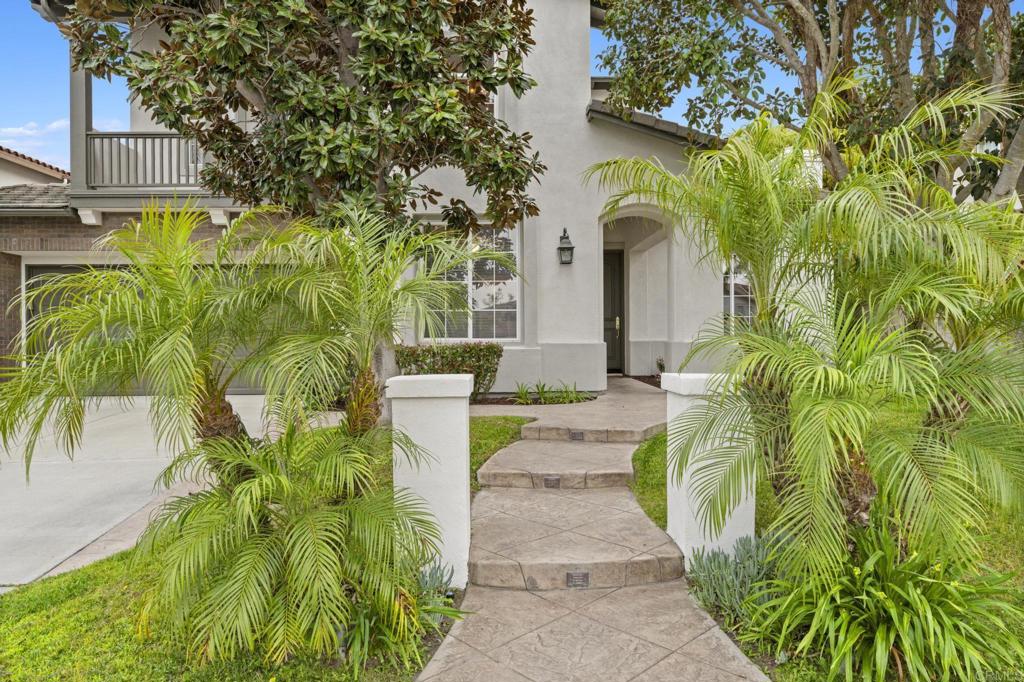 8021 Paseo Arrayan Carlsbad, CA 92009 - Photo 5 of 68 a front view of a house with a garden