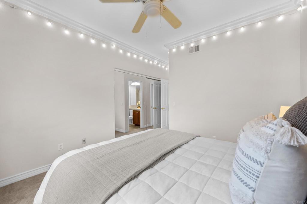 8021 Paseo Arrayan Carlsbad, CA 92009 - Photo 51 of 68 a bedroom with a large bed and chandelier