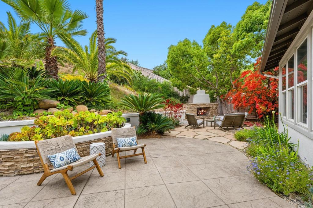 8021 Paseo Arrayan Carlsbad, CA 92009 - Photo 53 of 68 a view of a patio with a table and chairs under an umbrella