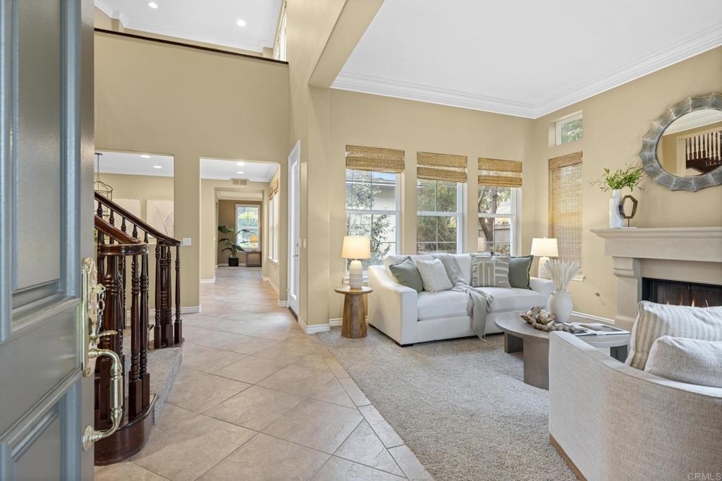 8021 Paseo Arrayan Carlsbad, CA 92009 - Photo 8 of 68 a living room with furniture a large window and a fireplace