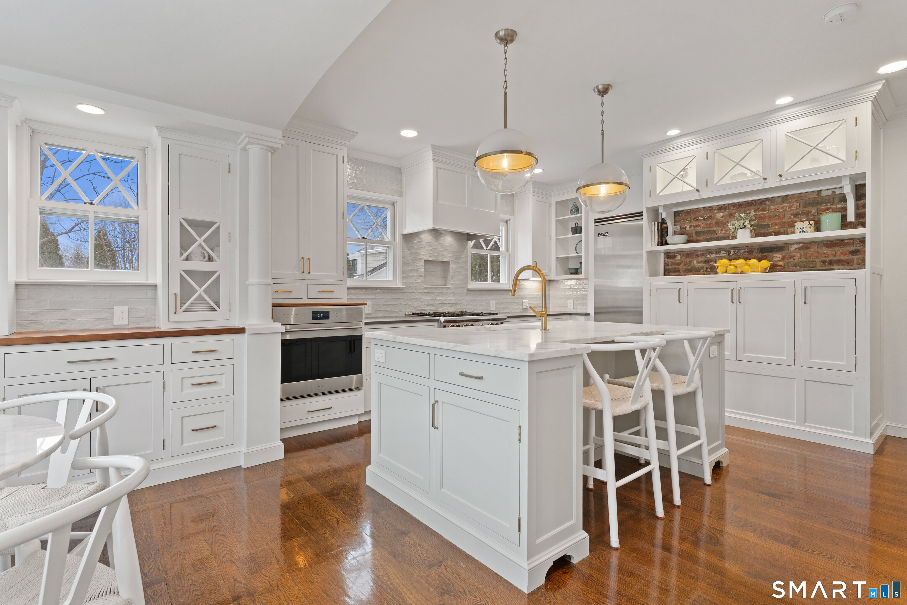 40 Rogers Road Stamford, CT 06902 - Photo 12 of 40 a kitchen with stainless steel appliances kitchen island granite countertop a stove a sink and white cabinets with wooden floor