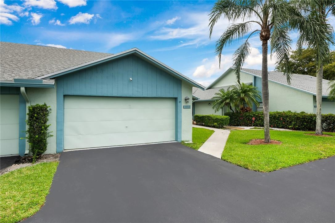 9085 Southwest 20th Street, Unit D Boca Raton, FL 33428 - Photo 1 of 25 a view of an house with backyard and swimming pool