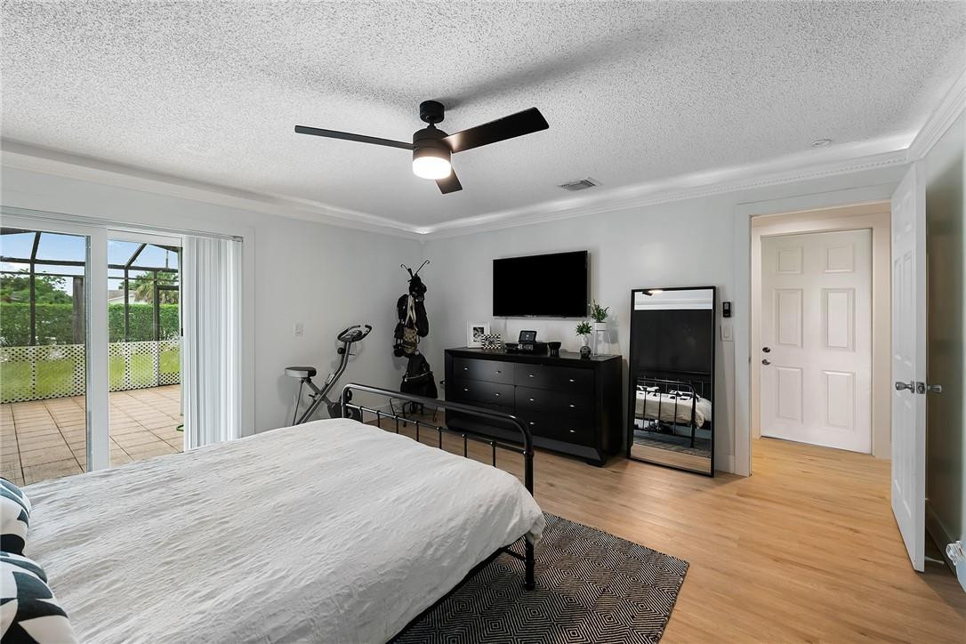 9085 Southwest 20th Street, Unit D Boca Raton, FL 33428 - Photo 11 of 25 a bedroom with a bed and a flat screen tv
