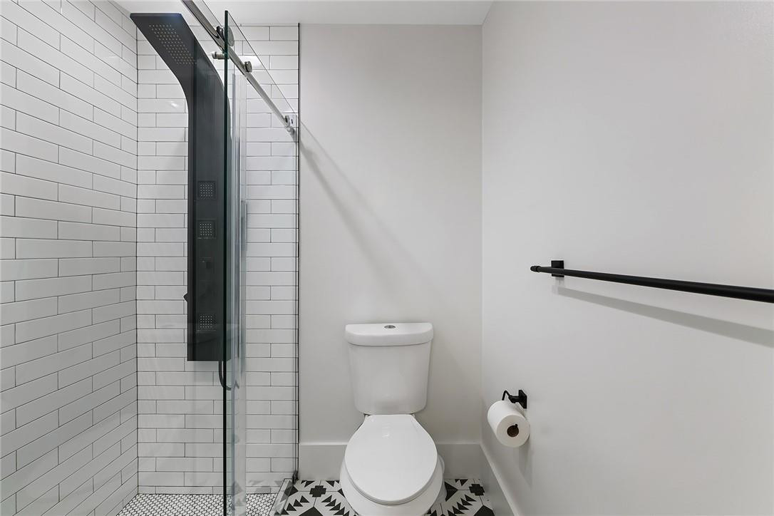 9085 Southwest 20th Street, Unit D Boca Raton, FL 33428 - Photo 14 of 25 a bathroom with a toilet and a shower