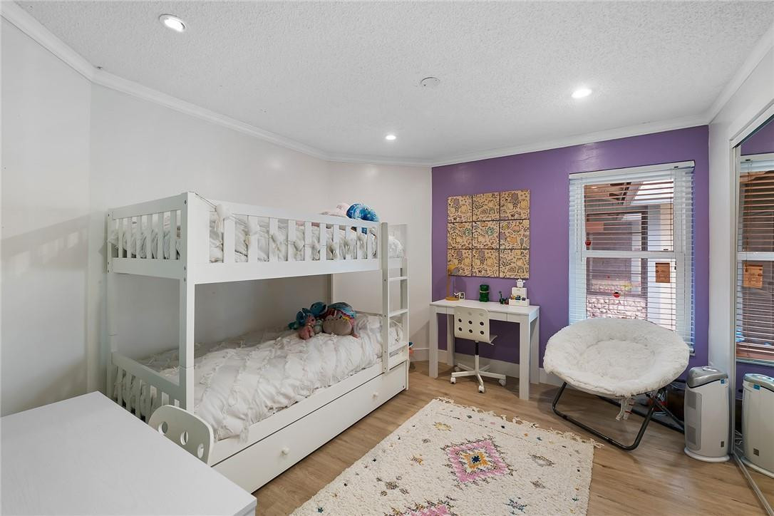 9085 Southwest 20th Street, Unit D Boca Raton, FL 33428 - Photo 15 of 25 a bedroom with a bed and a table in it
