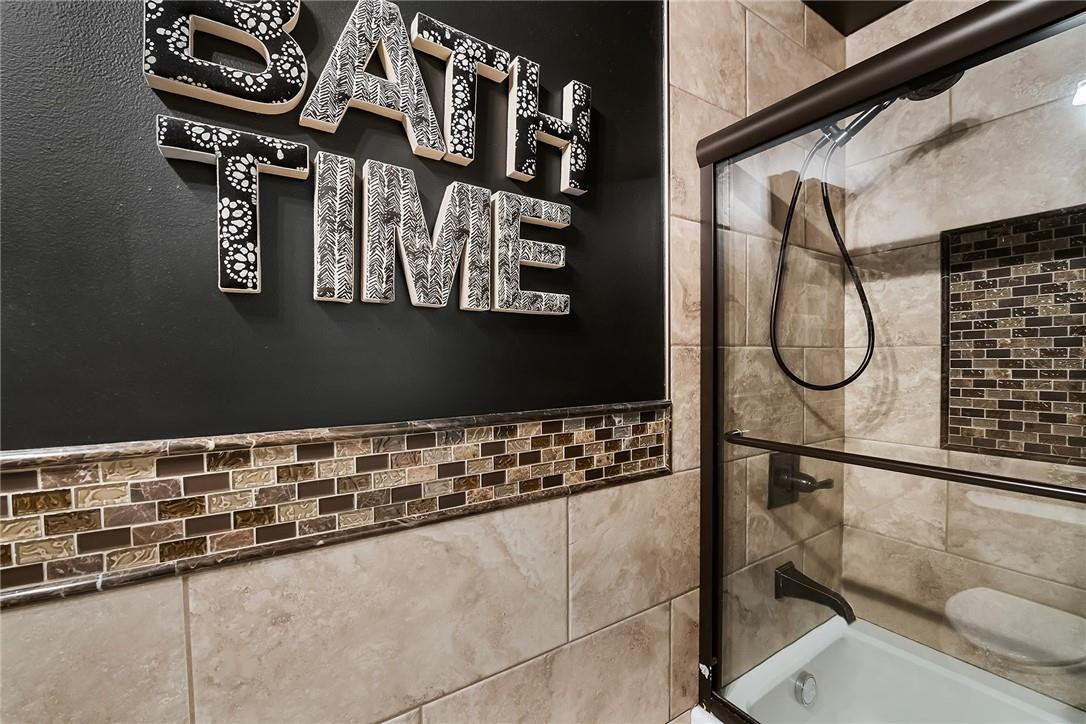 9085 Southwest 20th Street, Unit D Boca Raton, FL 33428 - Photo 17 of 25 a bathroom with a mirror and a shower